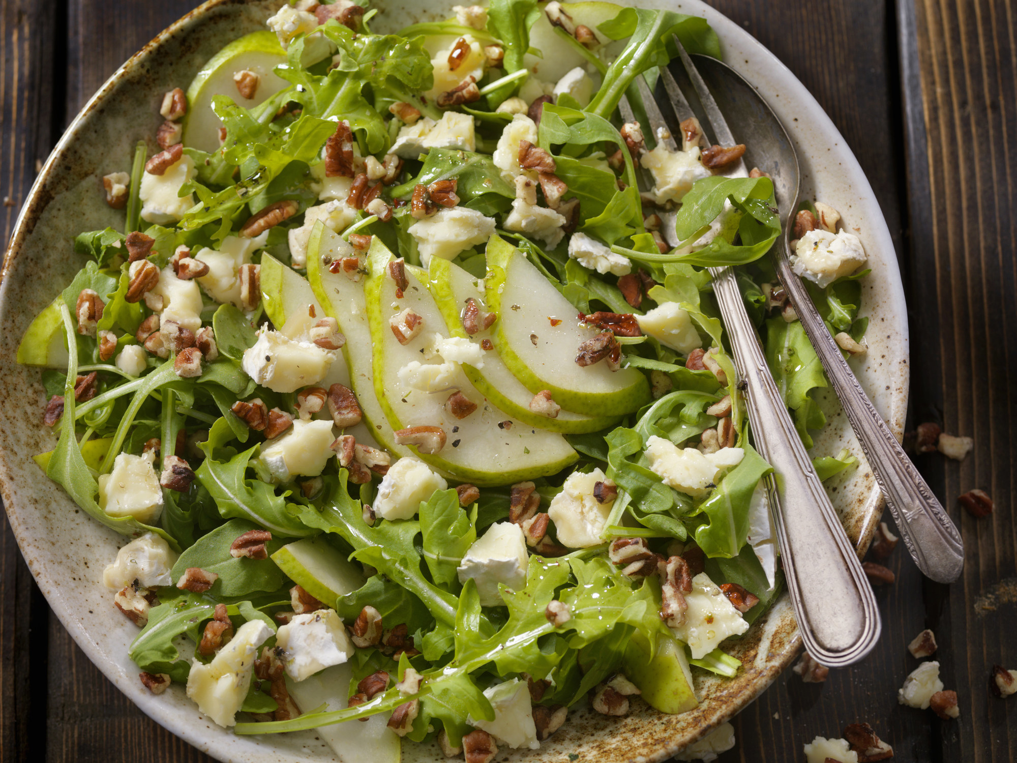 A salad with sliced pears.