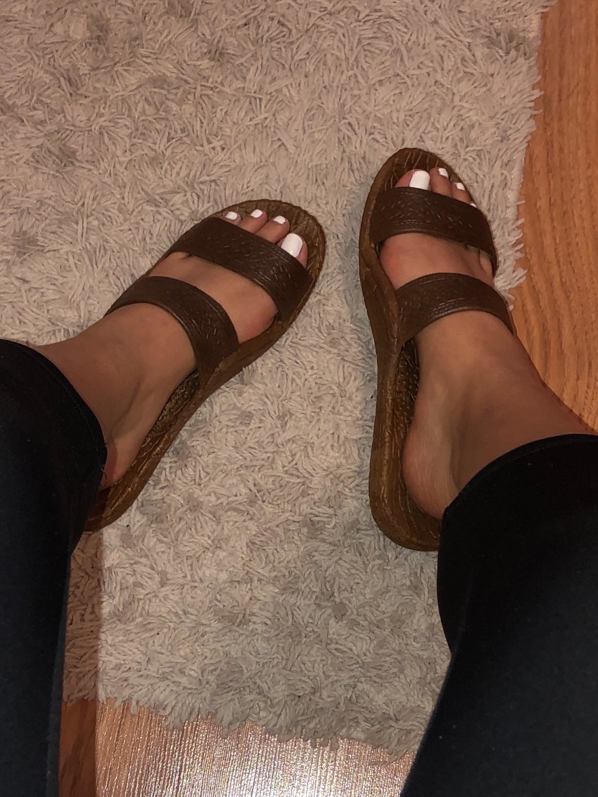 Reviewer wearing the slide sandals in brown