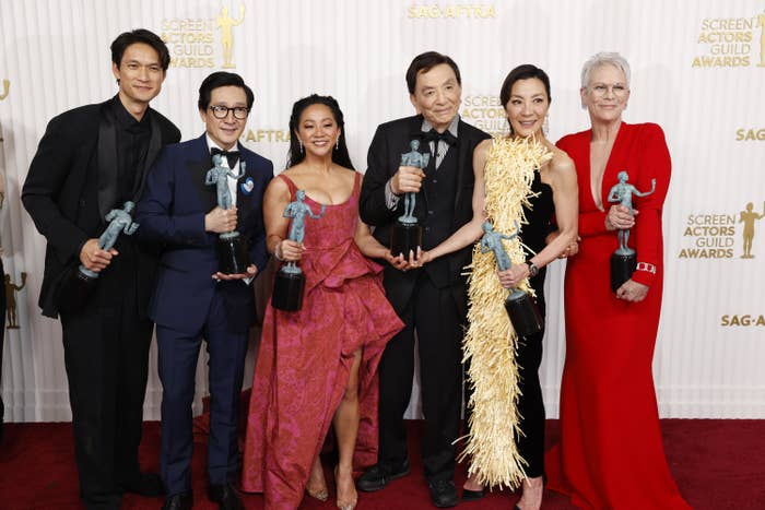 Harry Shum Jr., Ke Huy Quan, Stephanie Hsu, James Hong, Michelle Yeoh, and Jamie Lee Curtis hold their awards for best ensemble at the SAG Awards