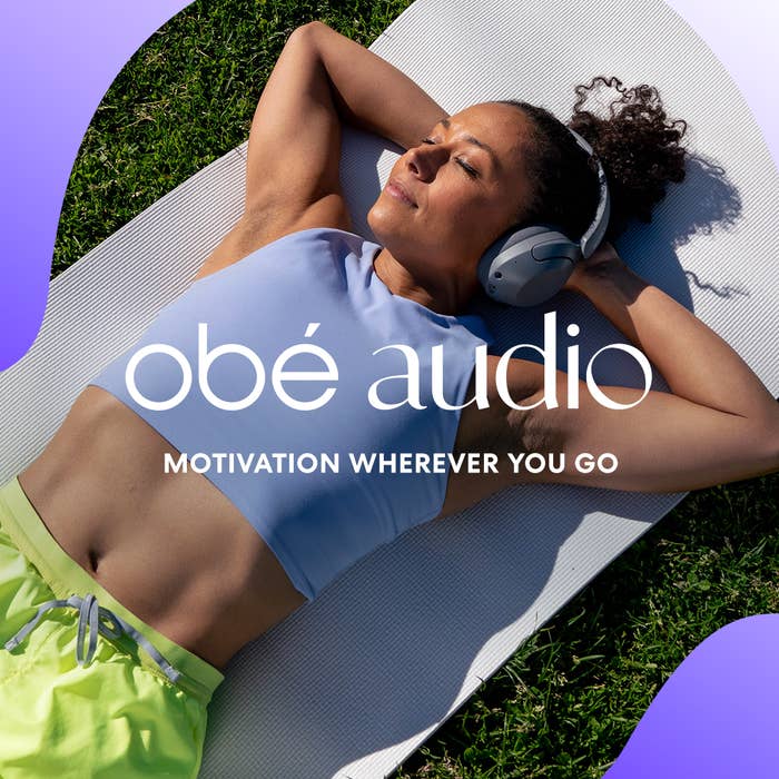 a person laying on a yoga mat with headphones on and text that says obe audio motivation wherever you go