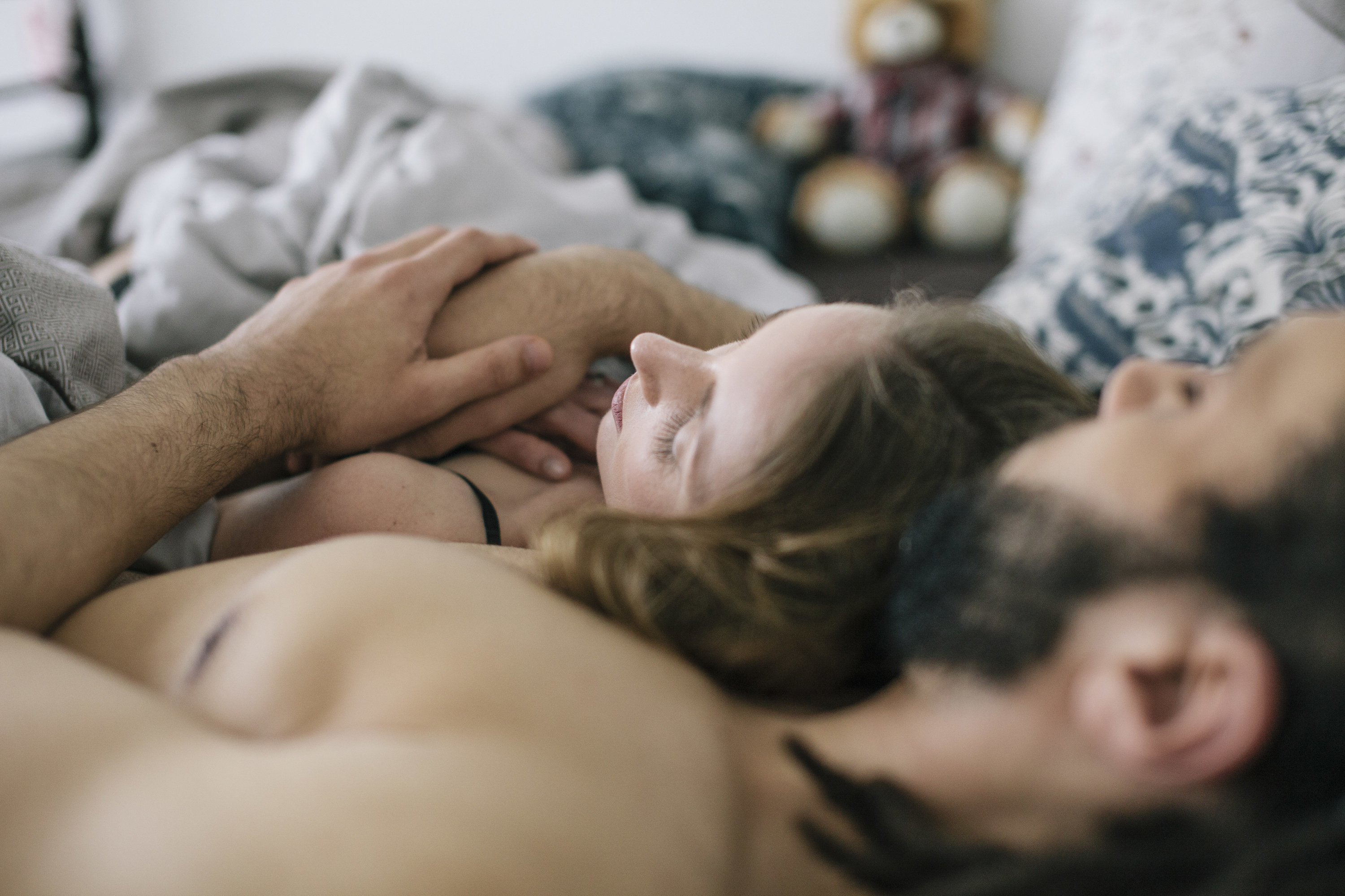 a couple cuddling in bed