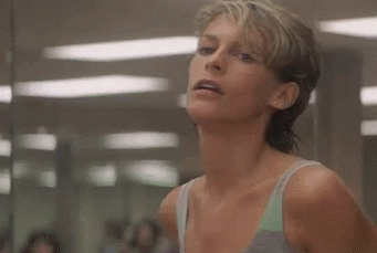 jamie lee curtis in a scene from perfect where she is doing an aerobics class