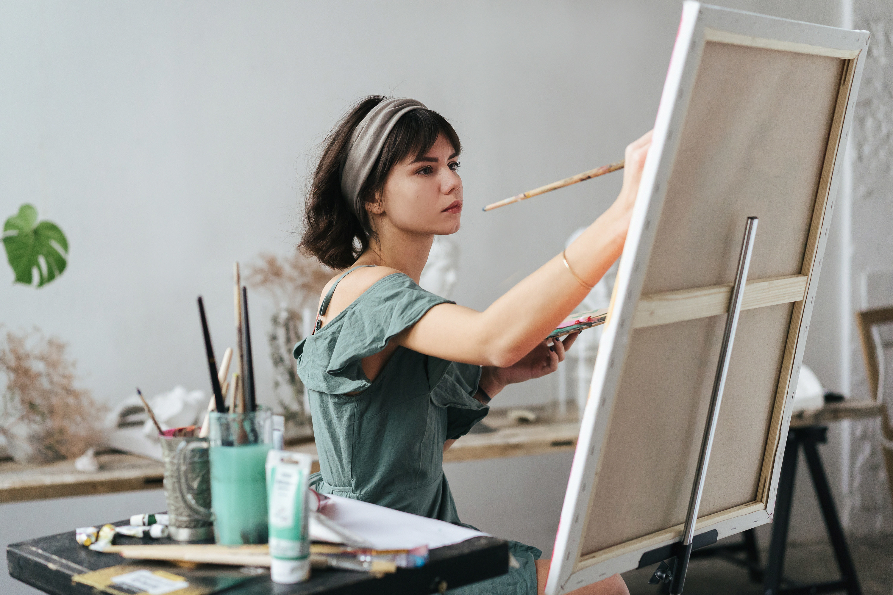 a woman painting on a canvas