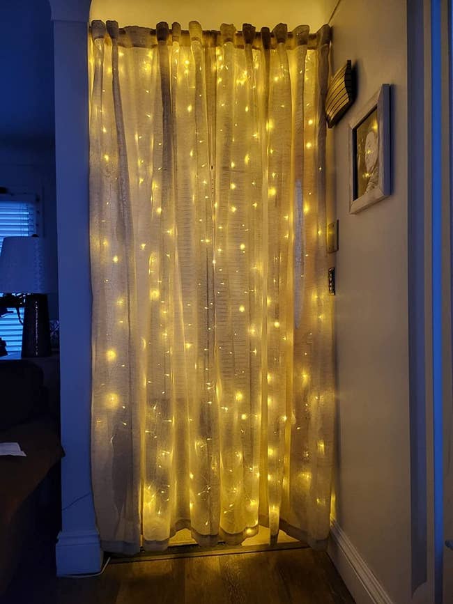 reviewer image of the lights curtain hanging in a doorway