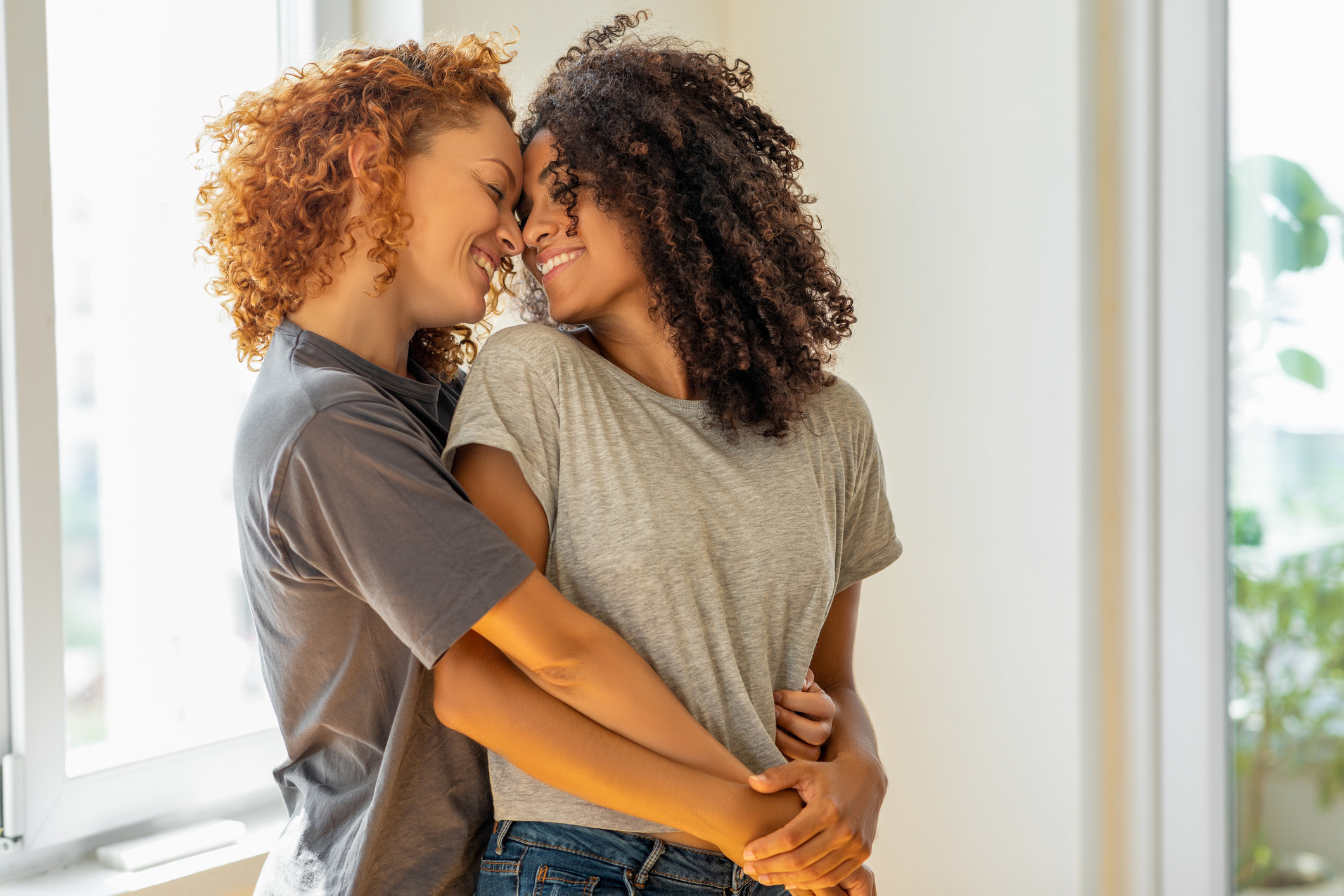 Two women hugging and staring into each other&#x27;s eyes