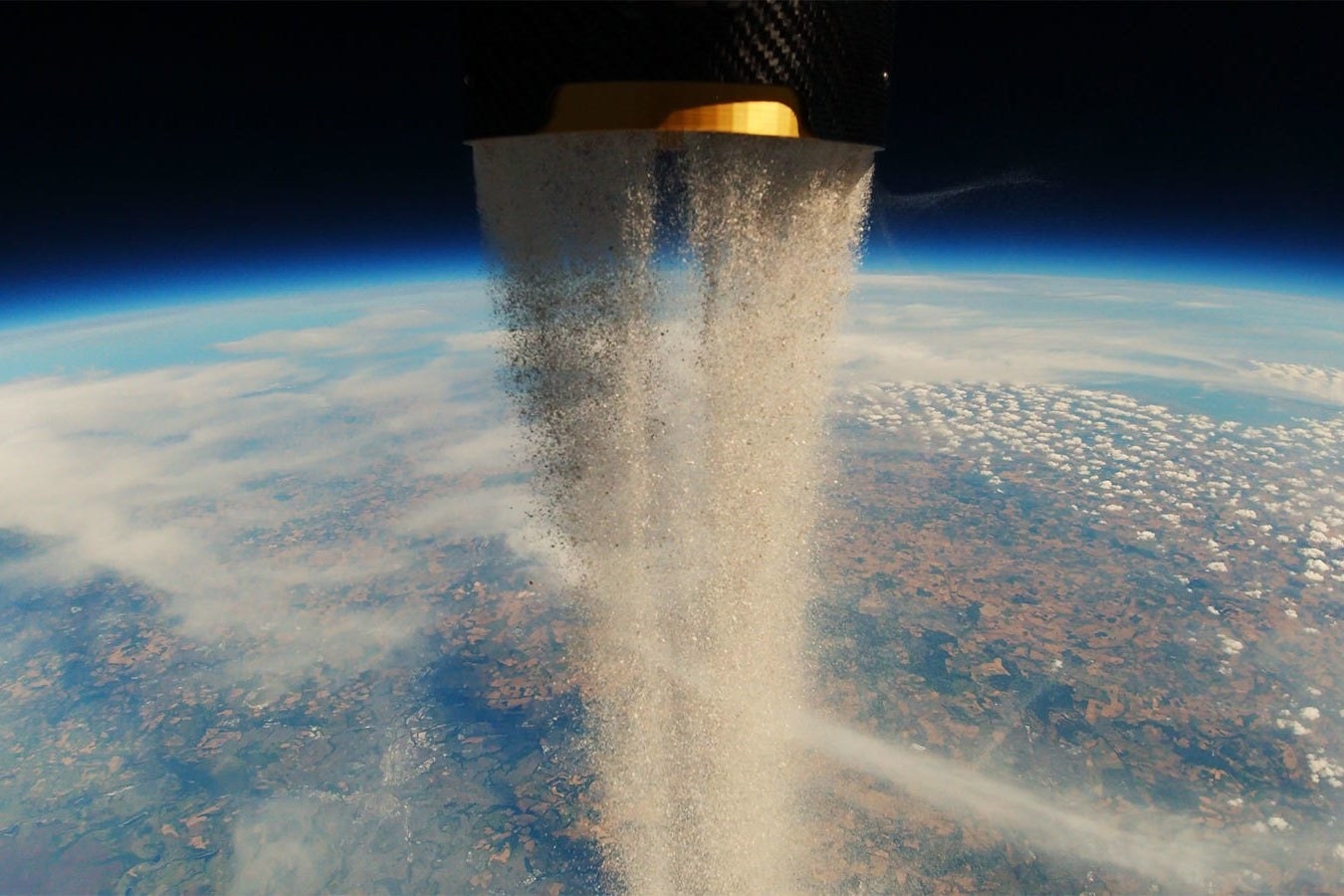 ashes being flung into space with planet earth in the background