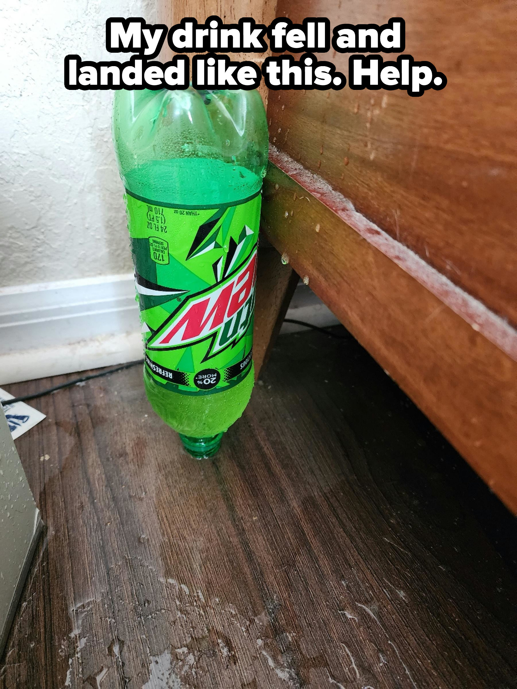 bottle of soda that has fallen in such a way that there is still liquid and if you move it it will spill