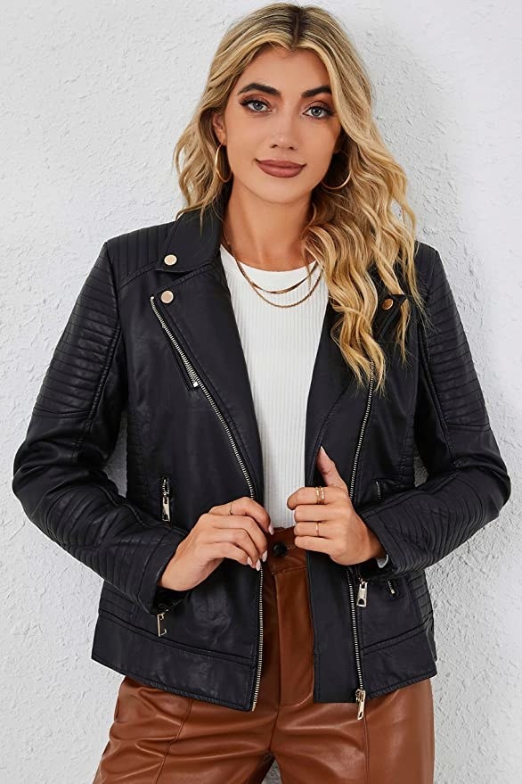 model wearing the leather jacket over a white top