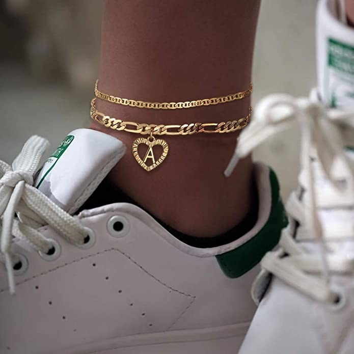 person wearing the anklets with stan smiths on