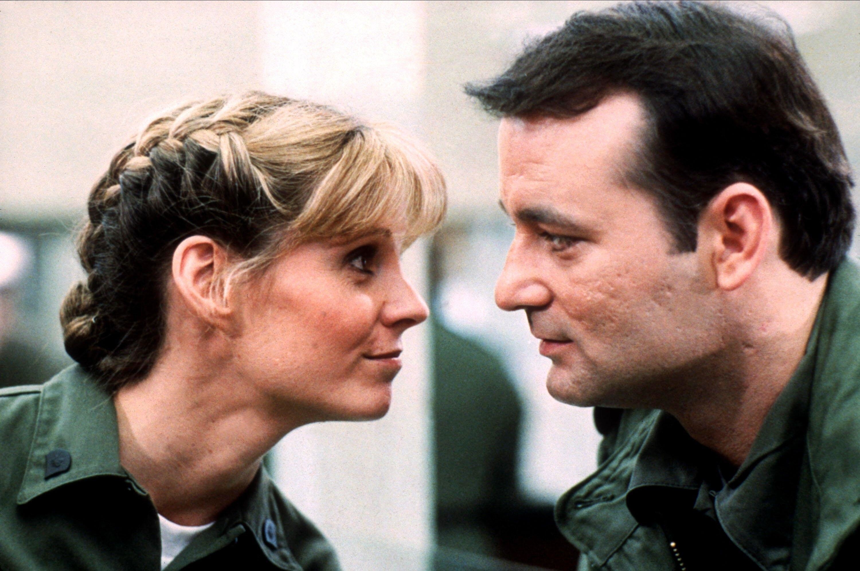 A male and female soldier draw close with a shared flirtatious glare