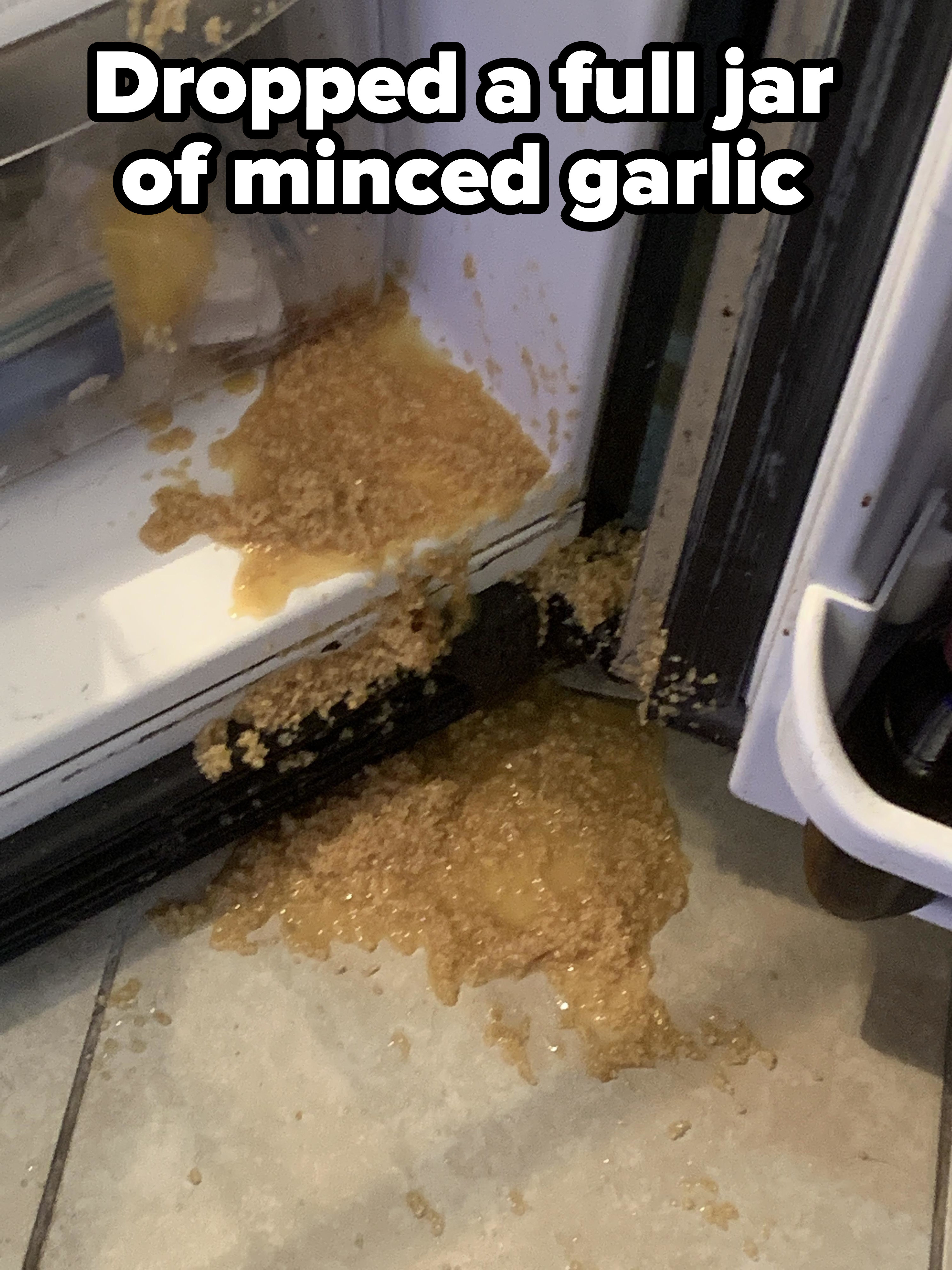 full jar of minced garlic spilled all over a fridge