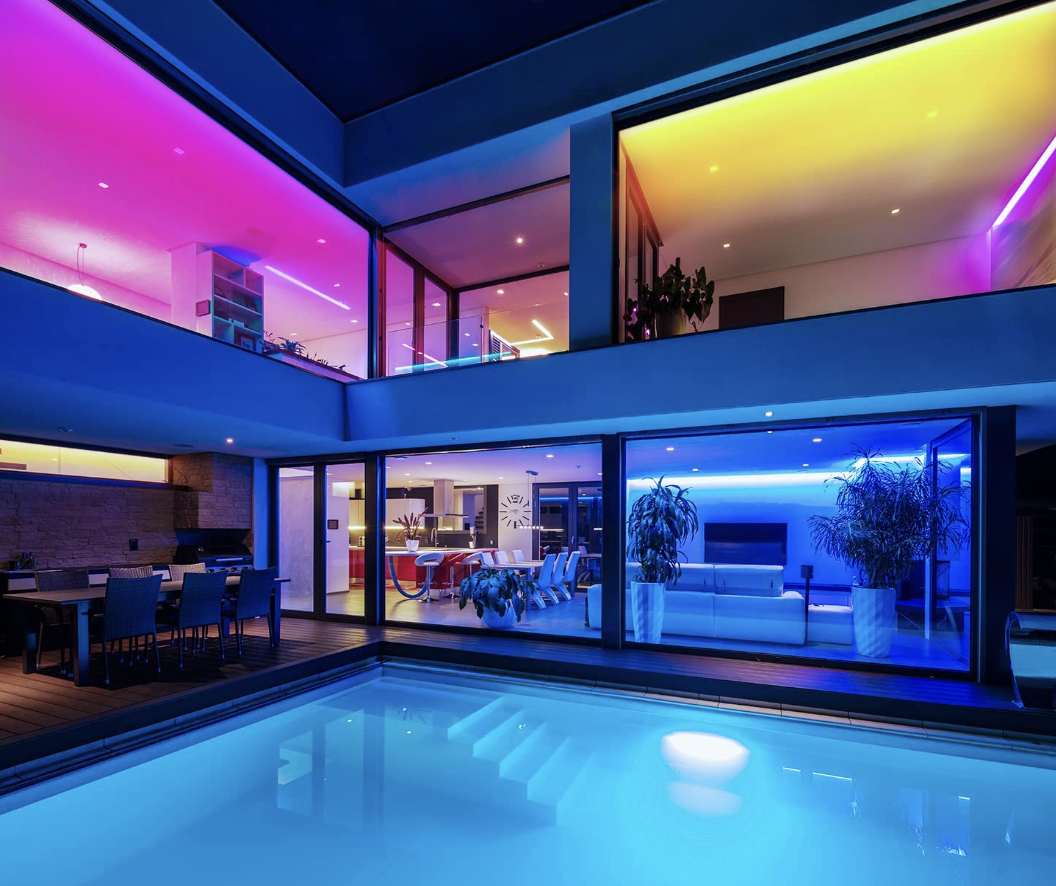 a house with different rooms lit up by different colours of the LED strips