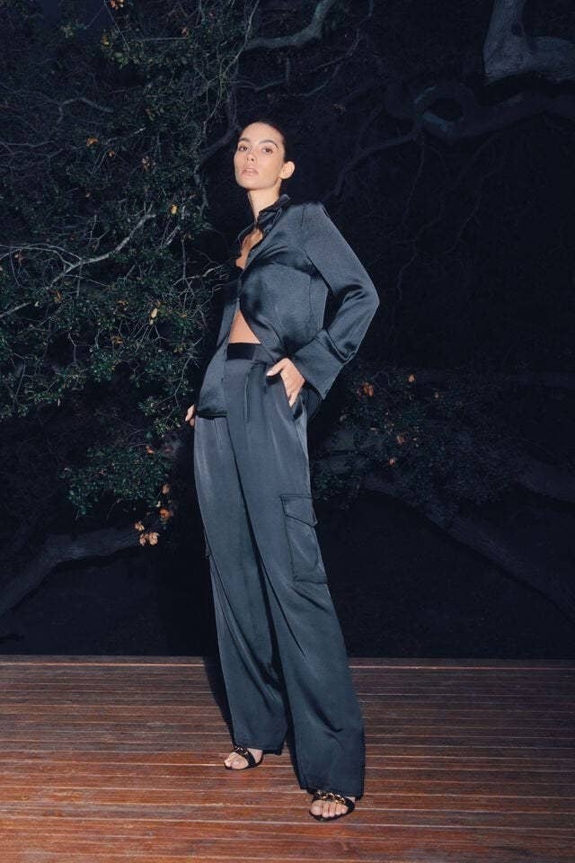 model standing on a deck wearing the satin pants and matching shirt