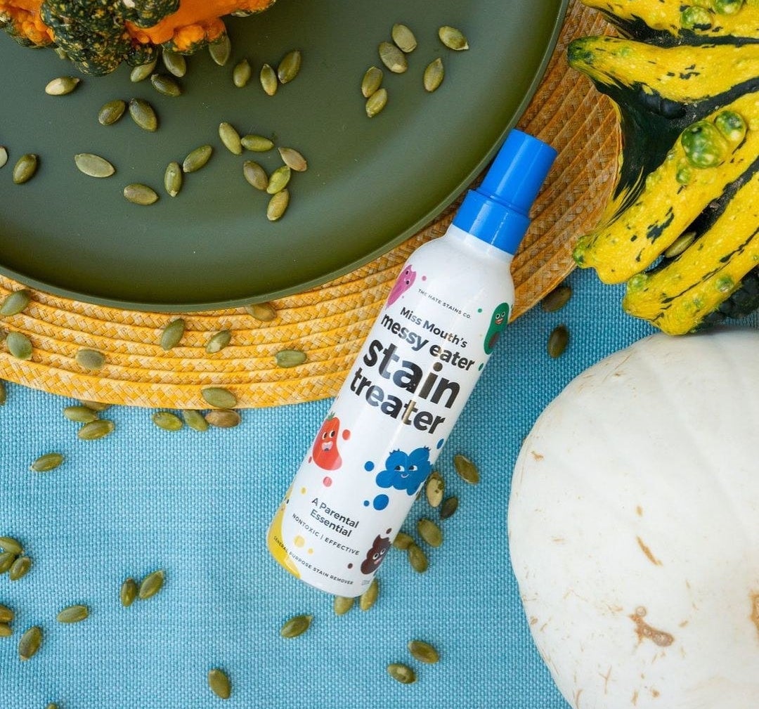a bottle of the stain remover on a messy tabletop