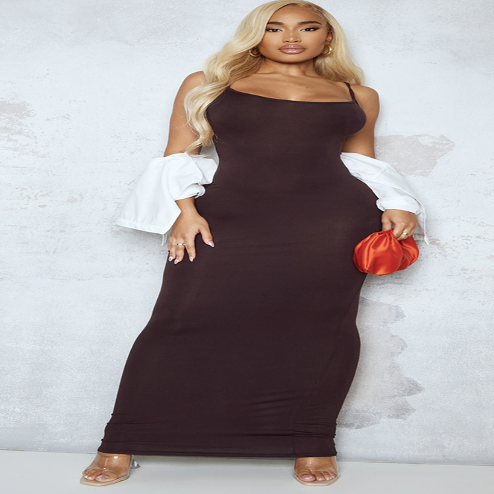 a model wearing the dress with a shawl and a bag