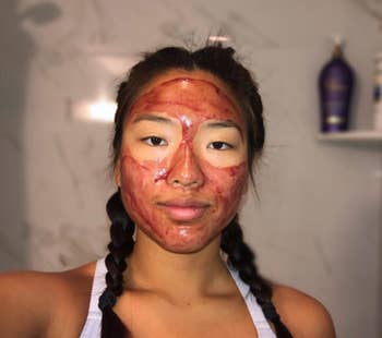 A reviewer with the red product all over their face