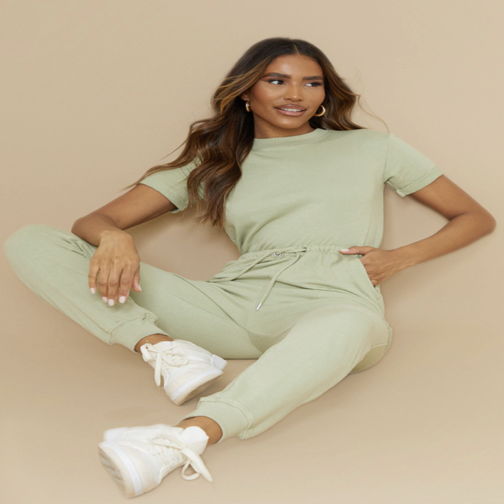 a model wearing the jumpsuit sitting down