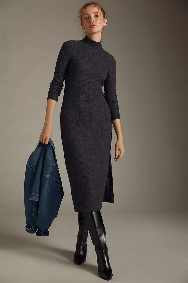 Model wearing grey sweater dress with black boots and denim jacket
