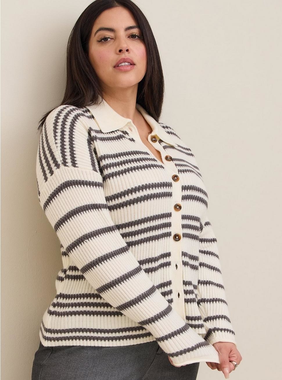 Model wearing black and white striped top with grey pants
