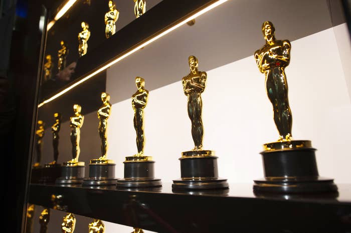 A row of Oscar trophies on a shelf