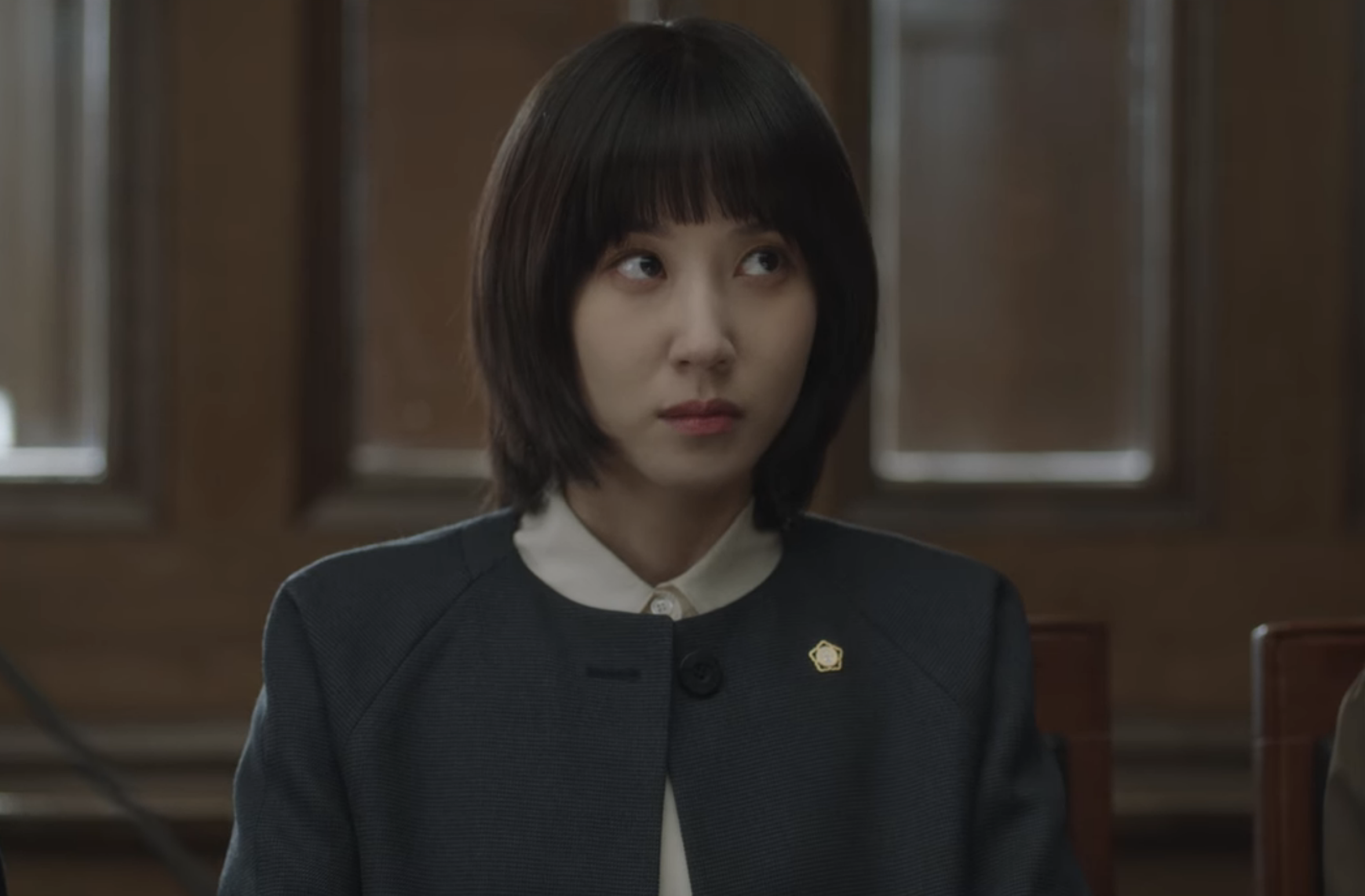 Woo Young-woo sitting at her desk in a court room