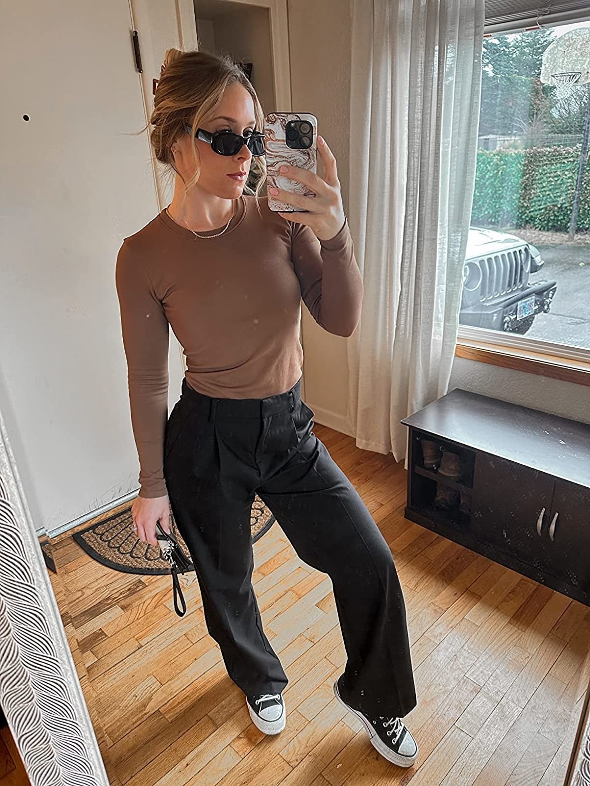 A reviewer wearing the tight long sleeve in light brown