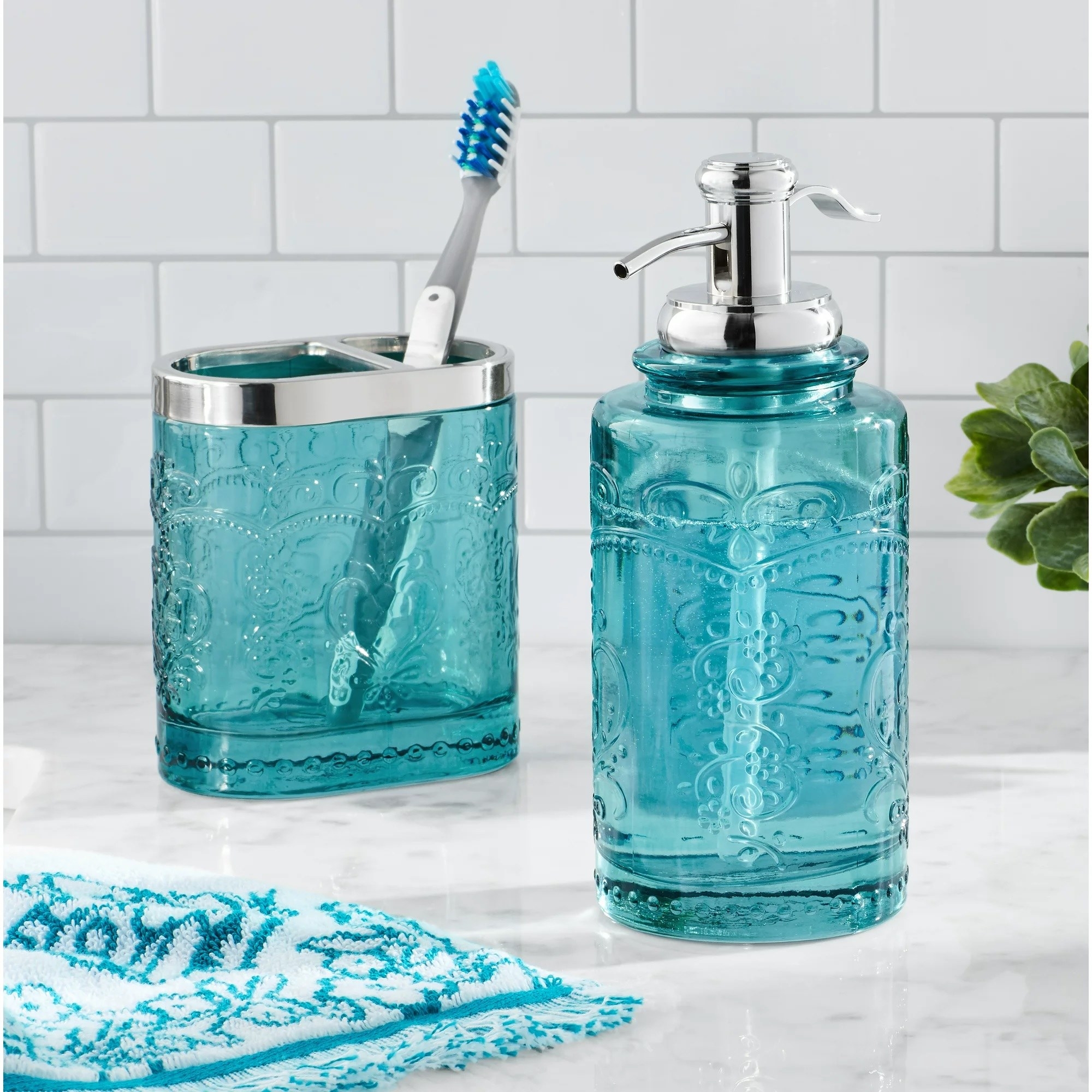 The teal bathroom set on the counter