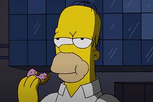 Homer Simpson eating a strawberry sprinkle donut