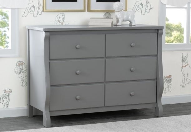 A gray dresser in a child&#x27;s bedroom