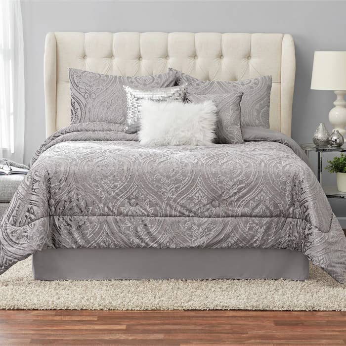 A comforter set on a bed in a bedroom