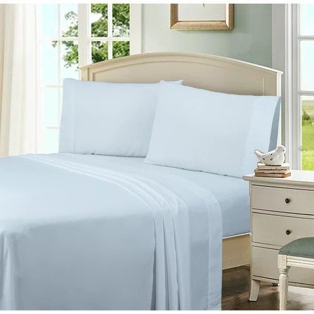 A white pillowcase set on pillows on a made bed