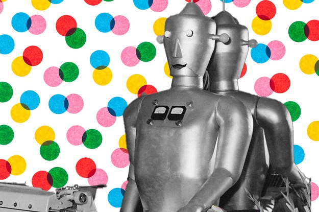 A vintage robot gazes at a typewriter in front of backdrop of blue, red, yellow, green, and pink dots