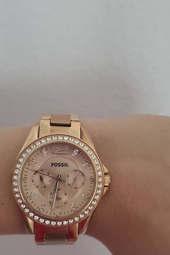 A reviewer wearing the rose gold watch
