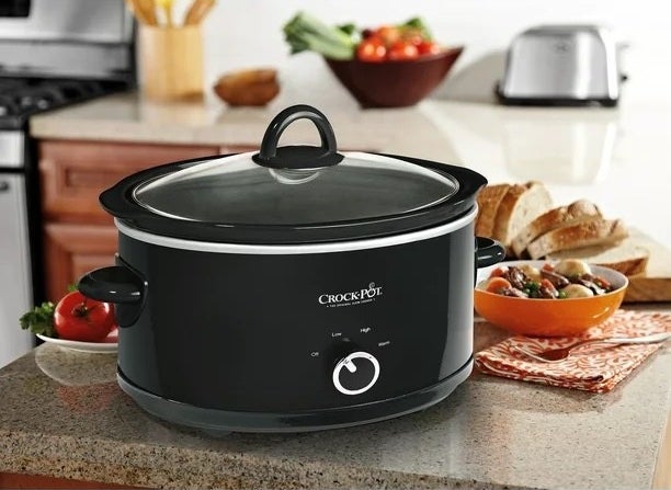 a black Crock-Pot slow cooker on a granite kitchen counter