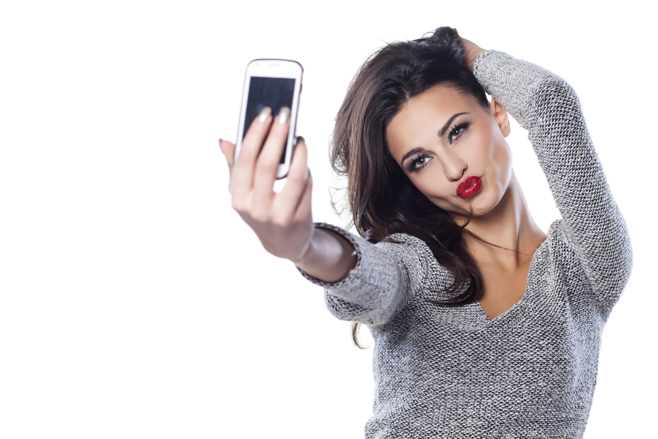 A woman taking a selfie and pursing her lips