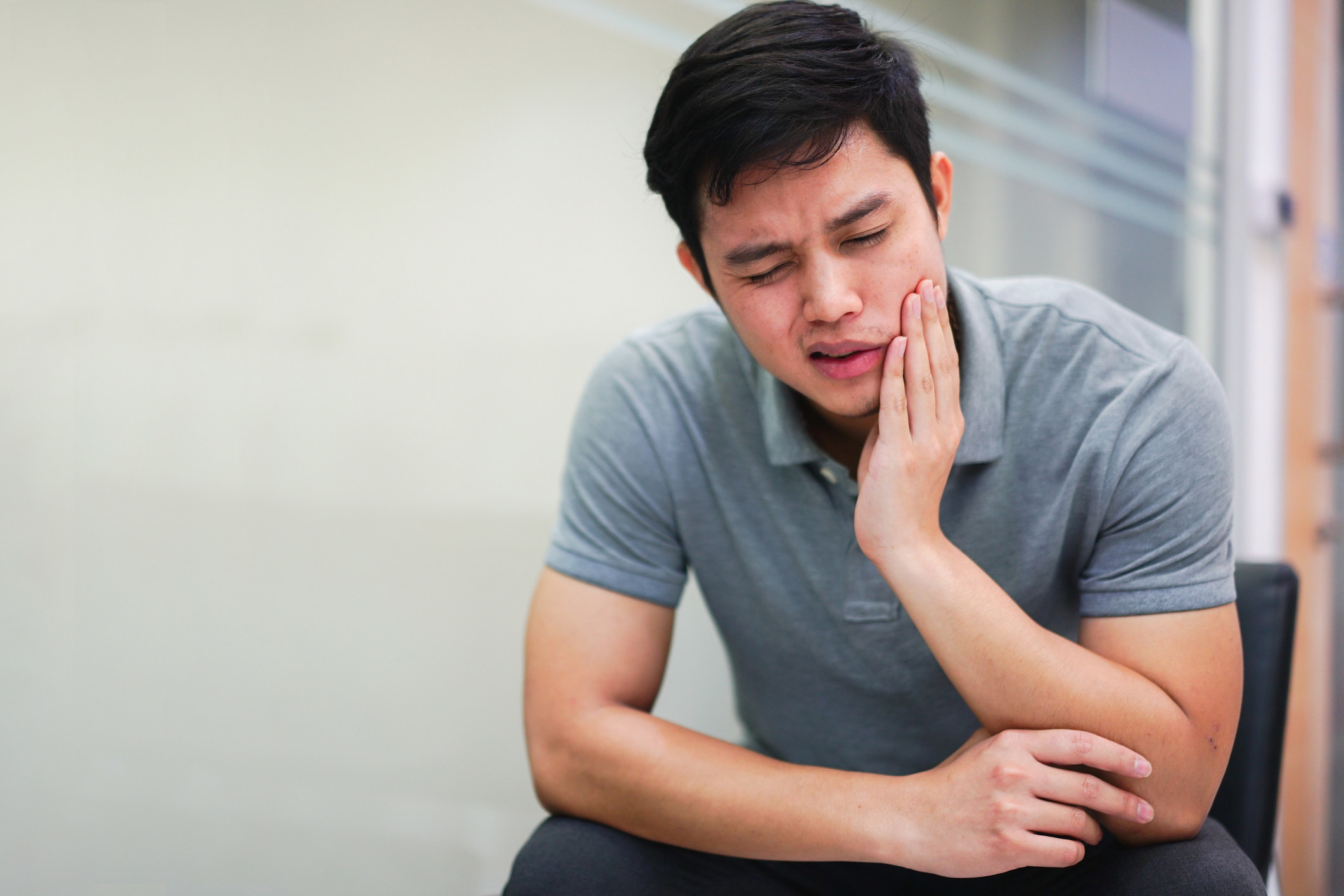 A man rubbing his jaw