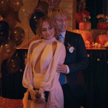 Jennifer Lopez and Owen Wilson posing for photos together in &quot;Marry Me&quot;