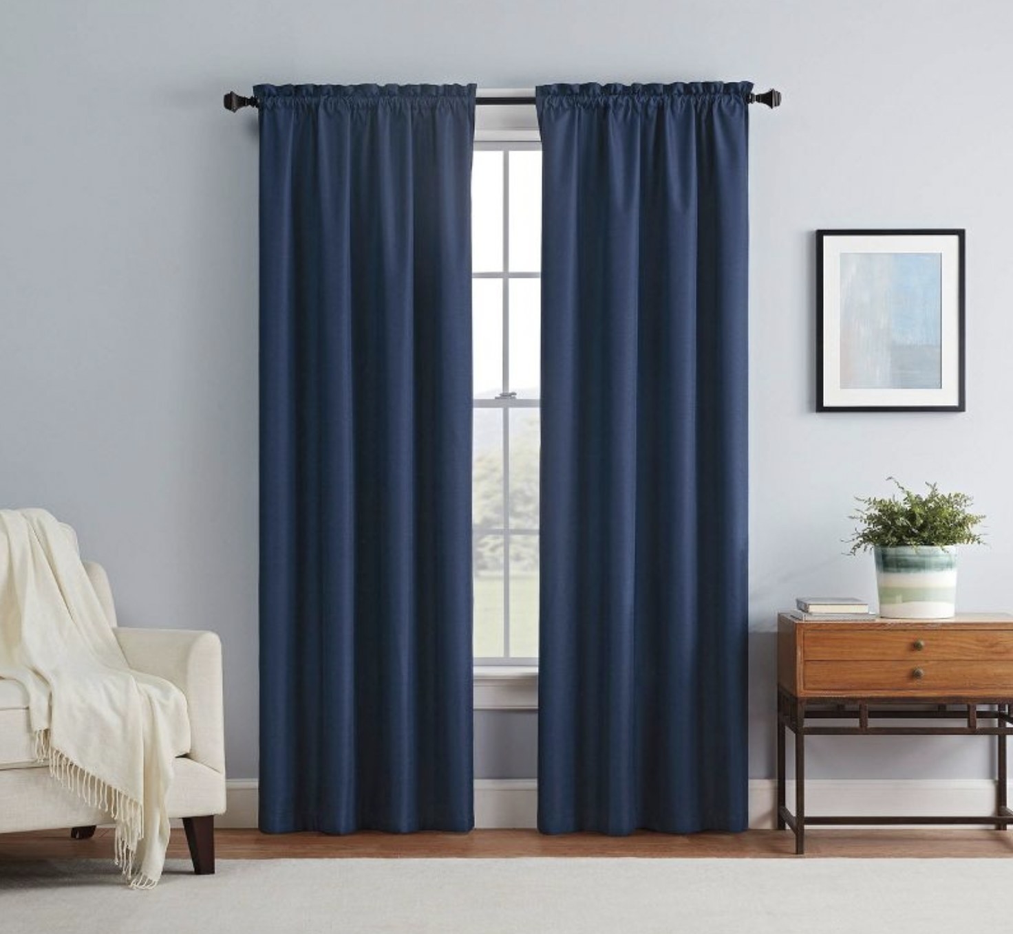 a pair of navy blue curtains hanging over a window