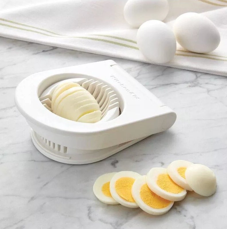 The egg slicer cutting a hard-boiled egg in several pieces