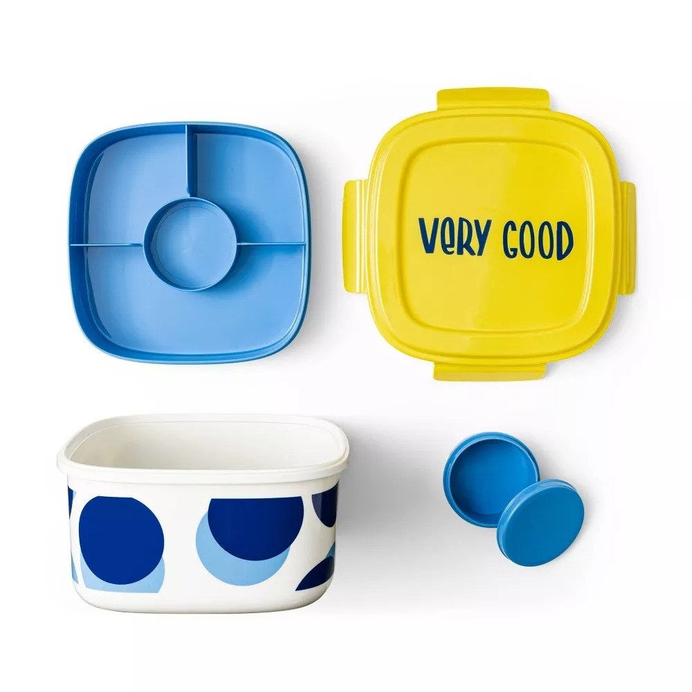 The salad container with an insert layer for four toppings, a dressing compartment, and a lid that says &#x27;very good&#x27;
