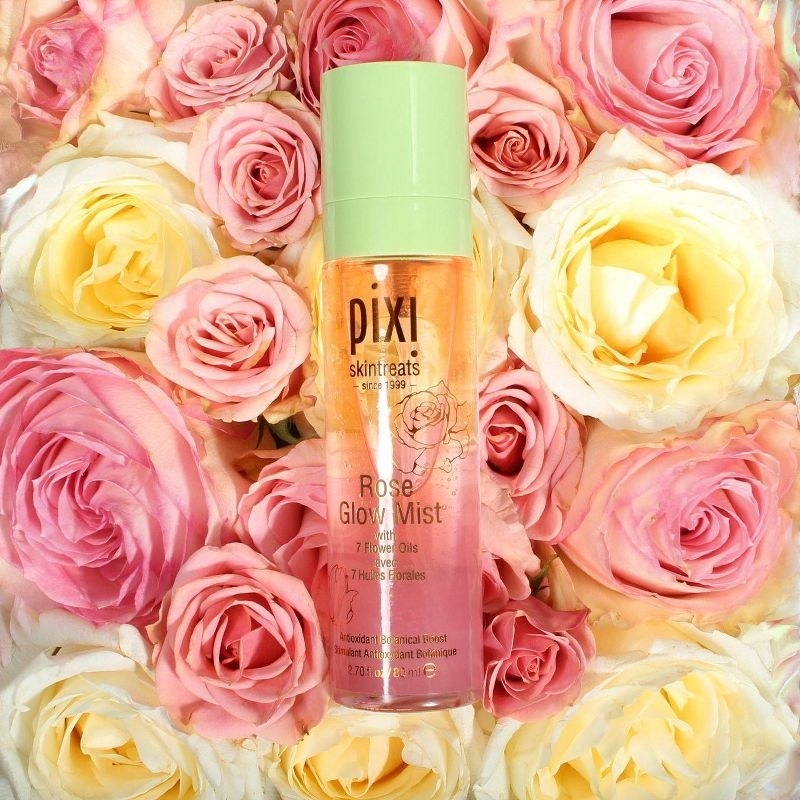 A bottle of face mist with multicolored roses