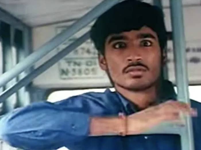 Dhanush holds onto a rod in a bus while looking angry