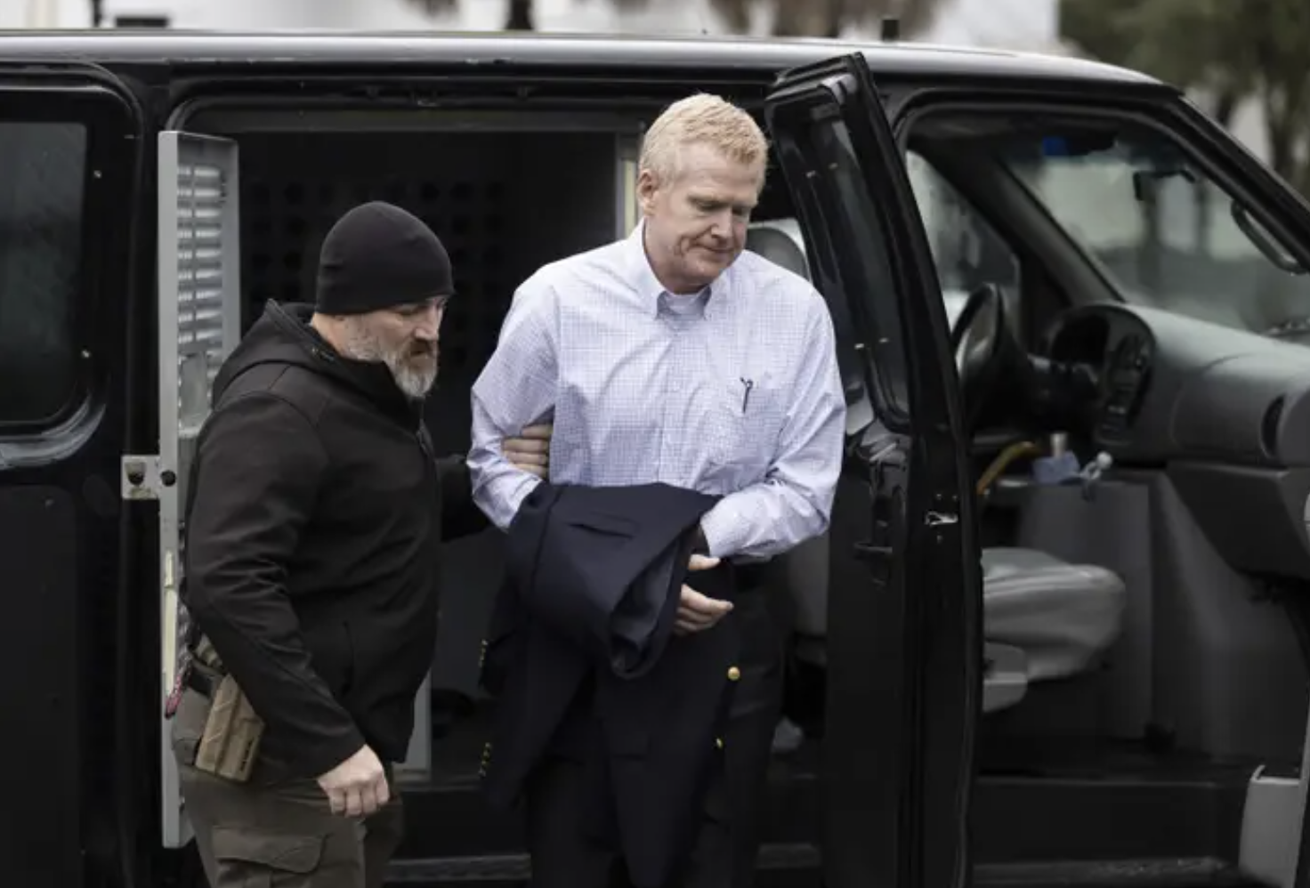 Alex Murdaugh being escorted out of a black car on the way to court