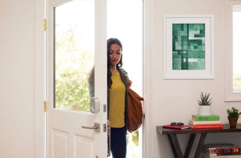 A person opening a door fitted with the smart lock