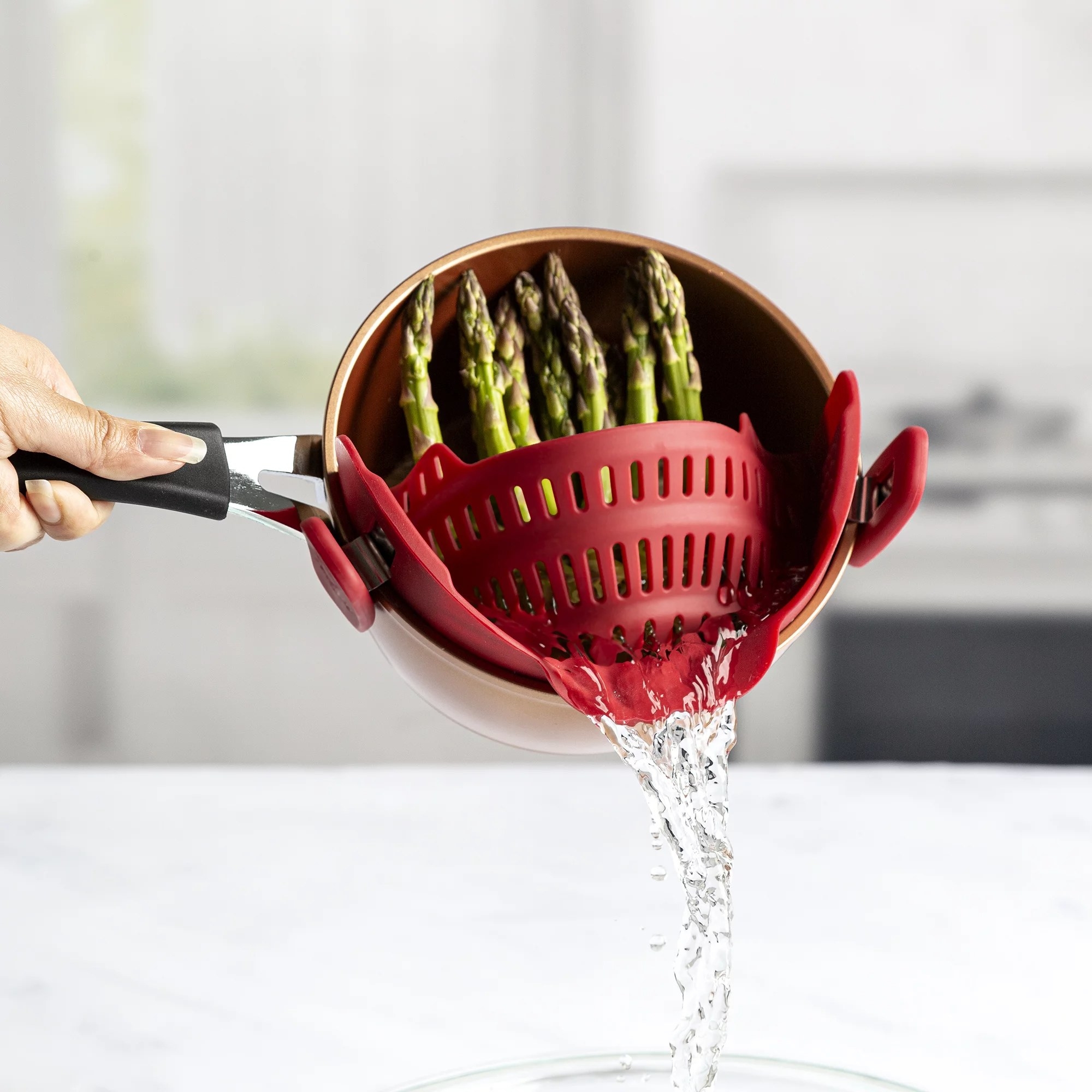 Every chef needs this adjustable silicone clip-on strainer for