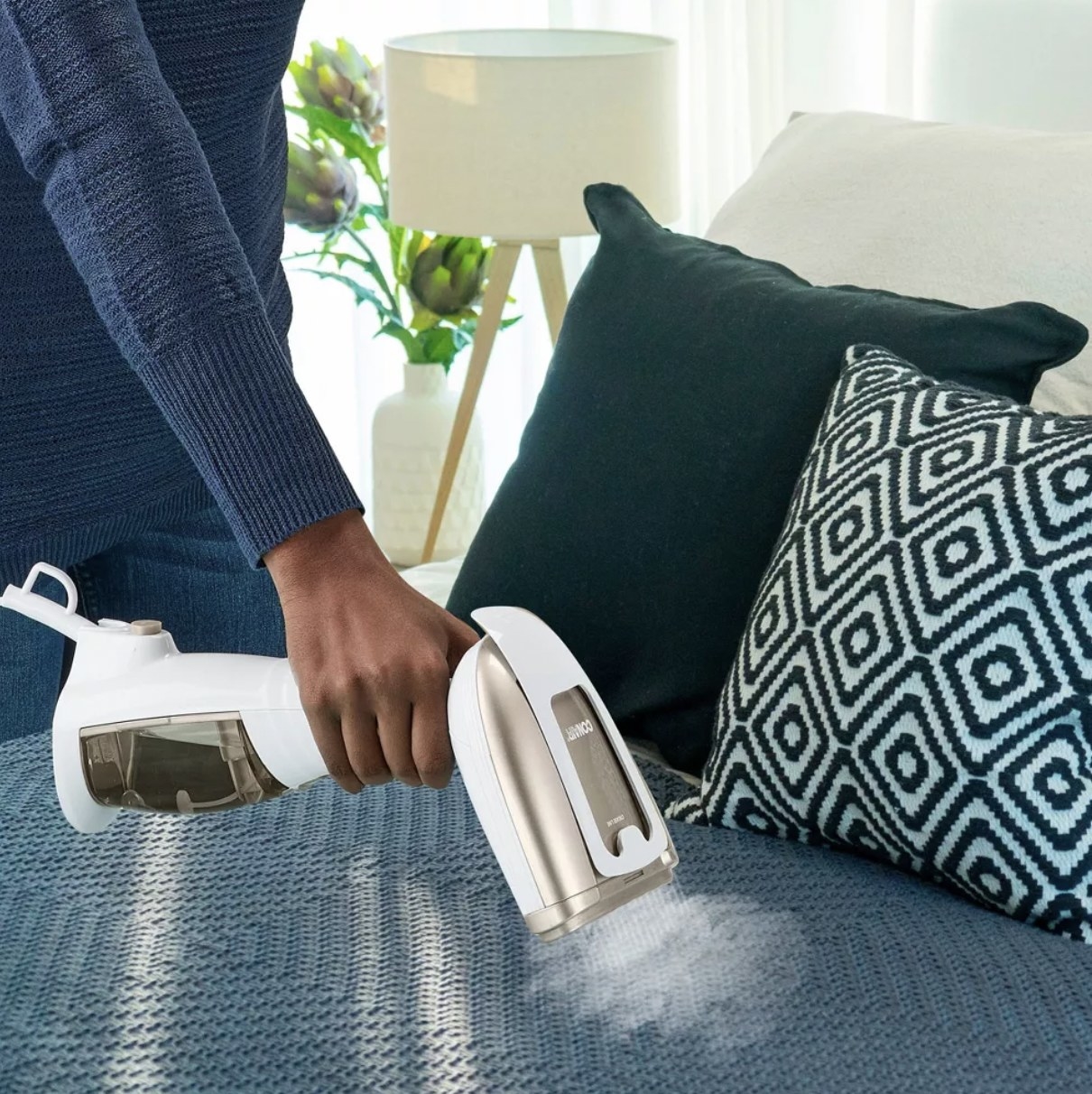 a model using the steamer on bedding