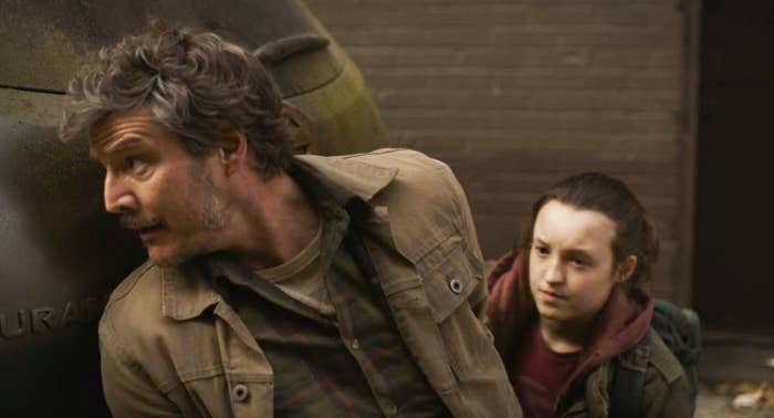 Pedro Pascal and Bella Ramsey hiding in a scene from &quot;The Last of Us&quot;