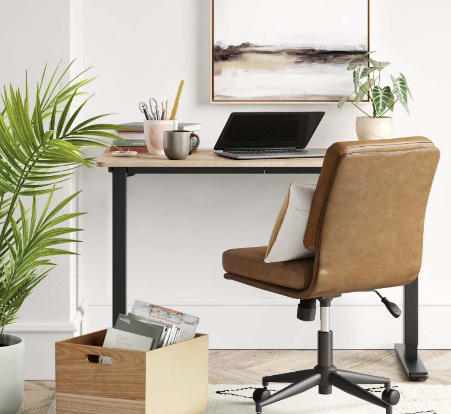 A desk and chair next to a plant