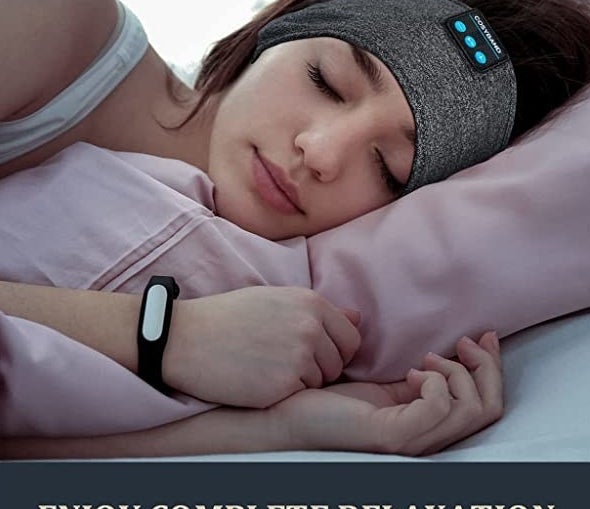 A model wearing the headphones in bed