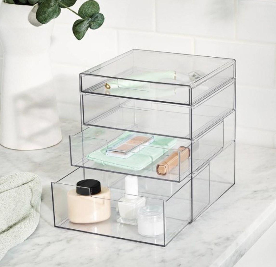 A clear organizer with cosmetic items in it